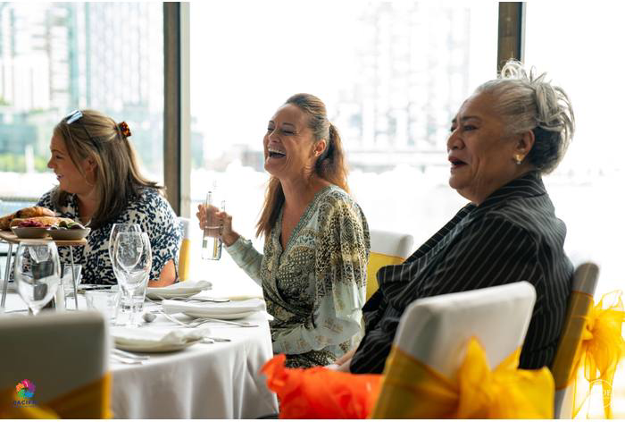 Guests laughing together around a table